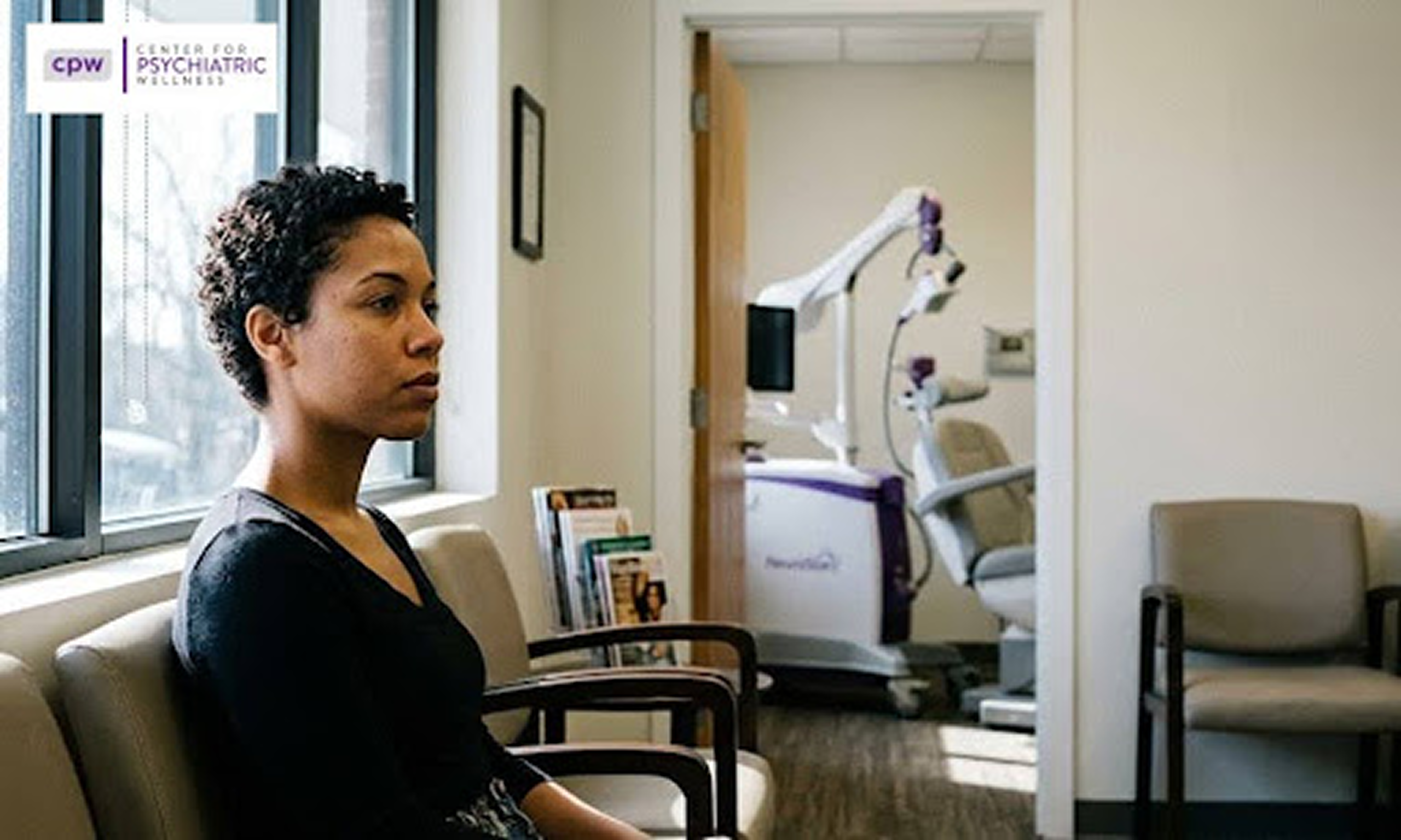 A picture of a woman in one of TMS clinic, sitting in a waiting room and waiting for her turn for the consultation or medication