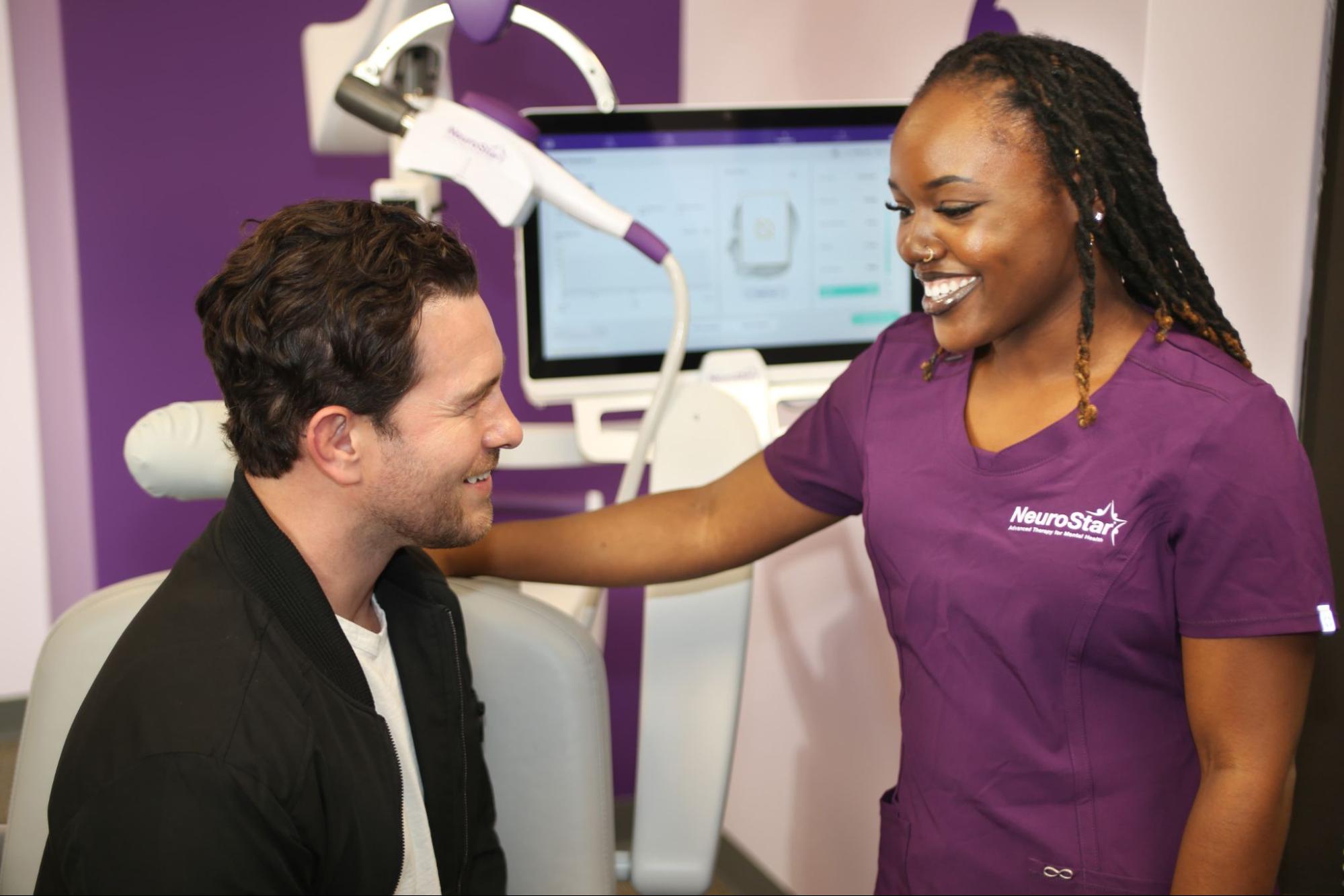 A patient's genuine smile during a NeuroStar TMS session and having conversation with the nurse.