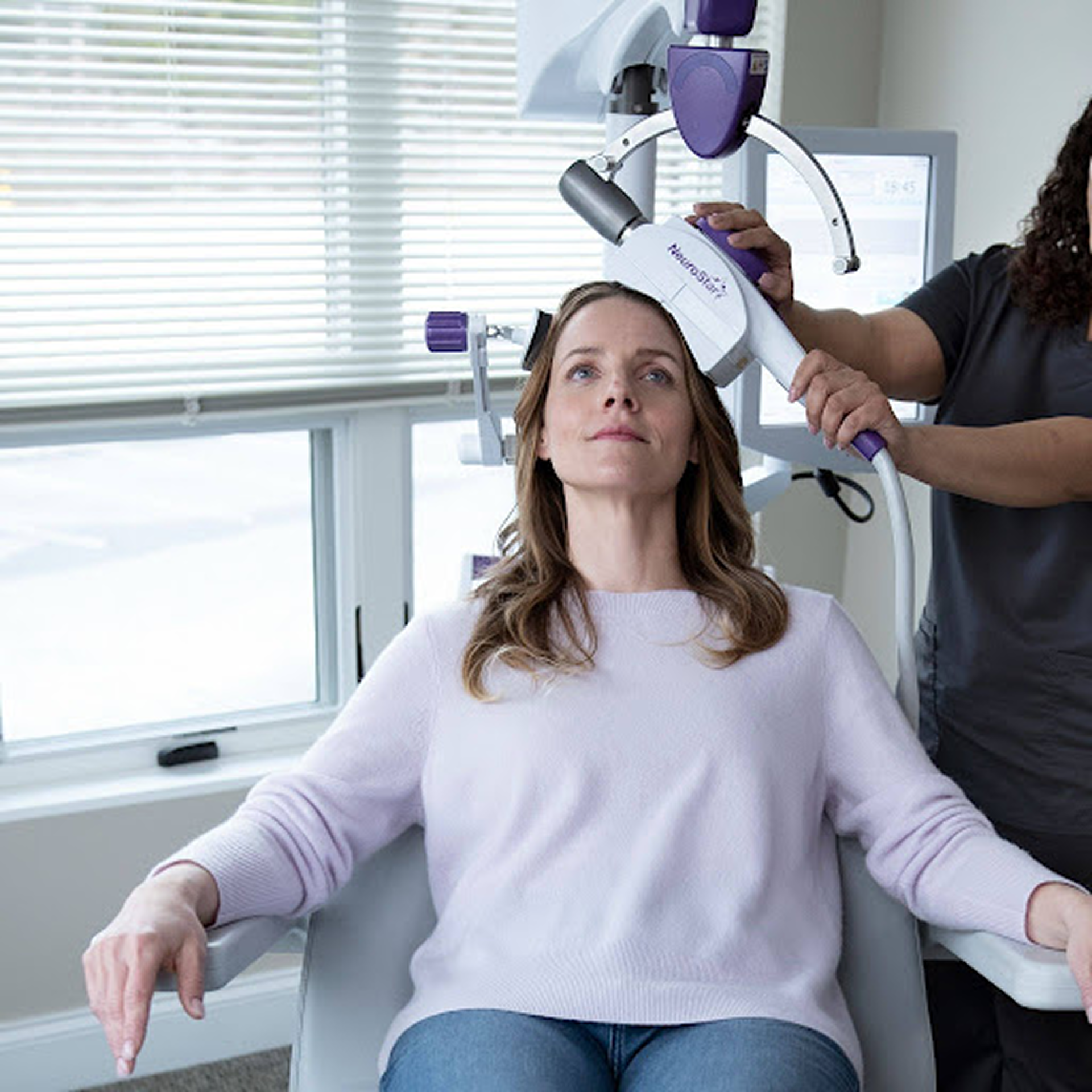 Clinician positioning NeuroStar TMS coil on patient are there any long-term effects of TMS on the brain